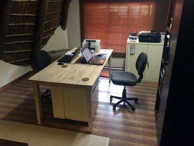 Removed old carpeting, installed PVC Tiles, sanded Desktop & painted legs & skirt.